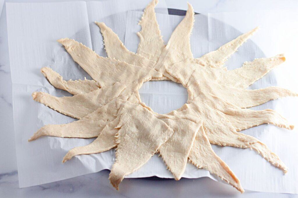 A sun shaped cookie on a plate.