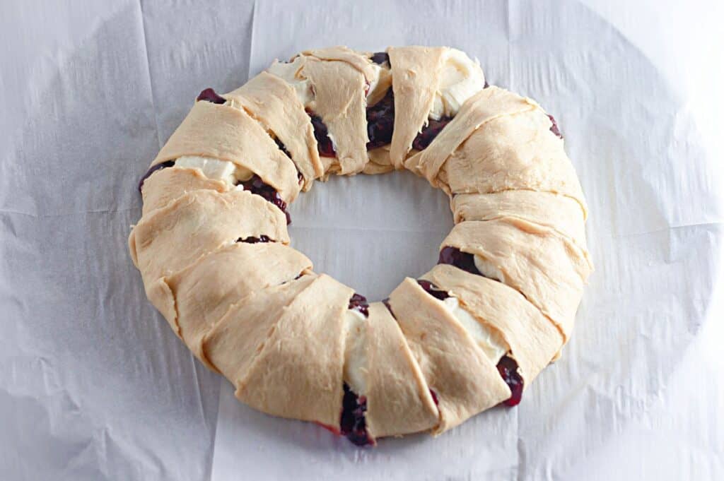A blueberry crescent roll on a white surface.