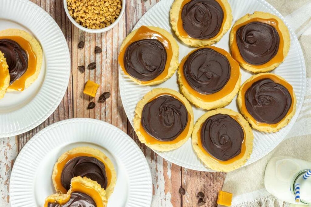 Three white plates with Crumbl Copycat Twix Cookies.