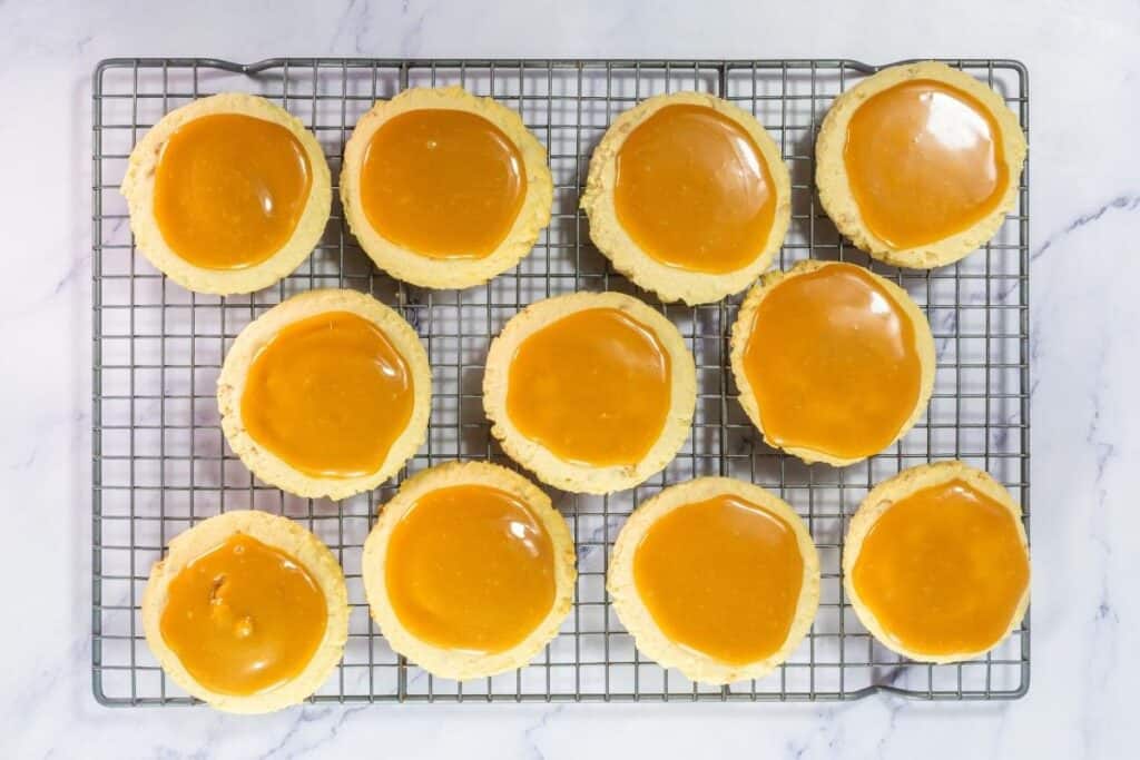 Spoon caramel over each cooled cookie and spread evenly.