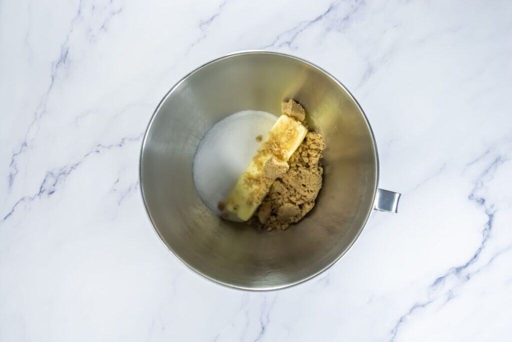 Granulated sugar, brown sugar, and softened butter ready to be creamed.