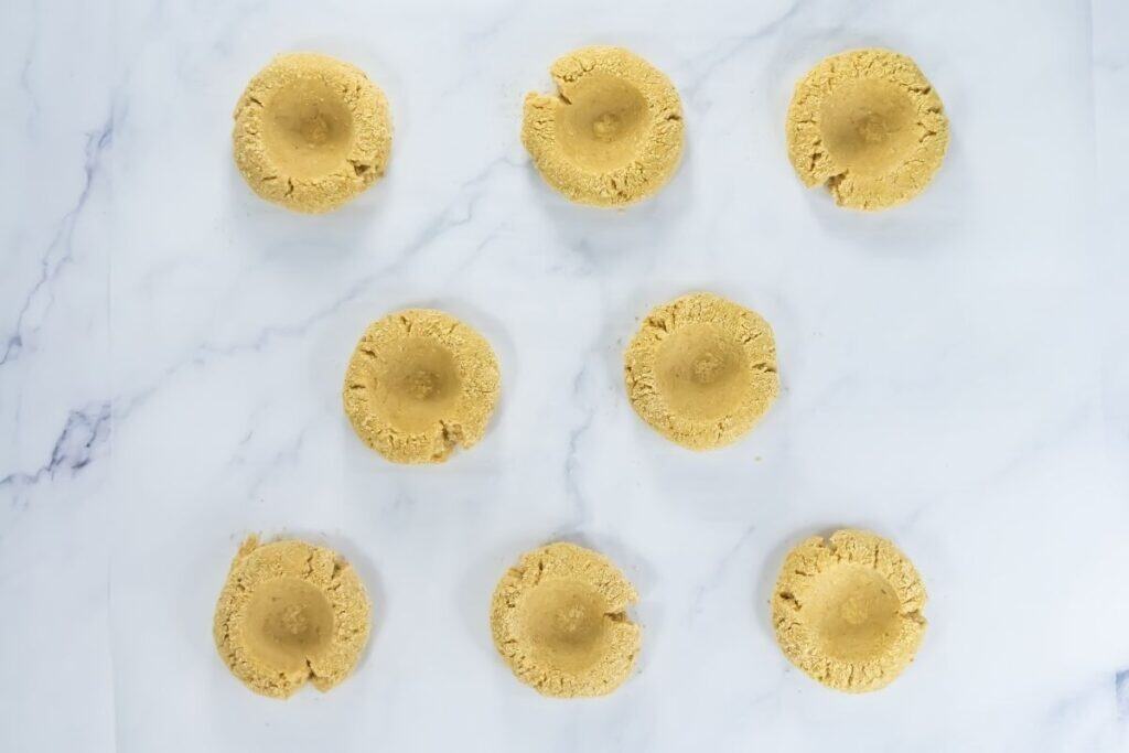 Each cookie has been pressed with a shallow center indentation.