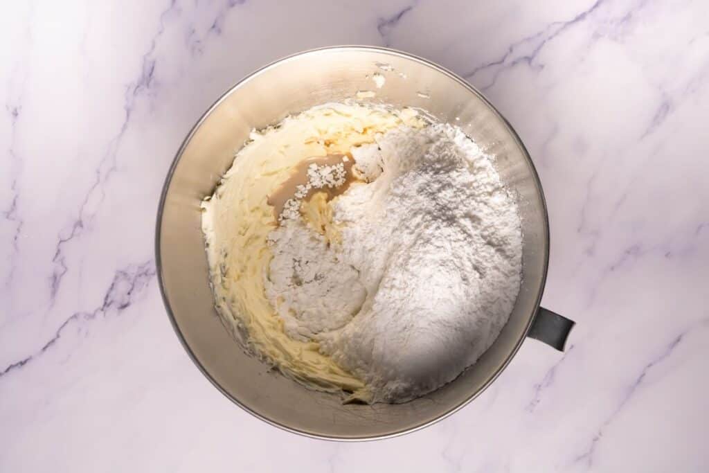 Vanilla extract and powdered sugar added to the cream cheese and butter mixture.