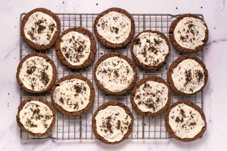 Delicious chocolate cookie cups topped with creamy frosting and chocolate sprinkles, perfect for baking lovers.