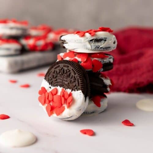 Valentine's day Oreos with heart-shaped sprinkles.