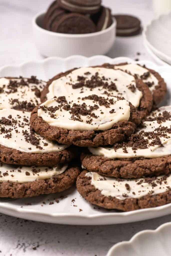 Delicious chocolate cookie cups topped with creamy frosting and chocolate sprinkles, perfect for baking lovers.