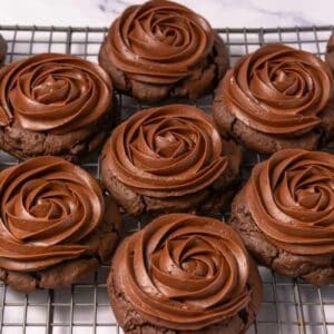 Crumbl copycat chocolate cake cookies on a metal rack.