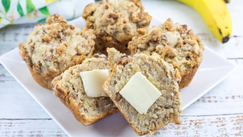 Banana Nut Muffins with Nutty Crumble Topping on a white plate.