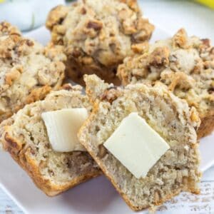 Banana Nut Muffins with Nutty Crumble Topping on a white plate.