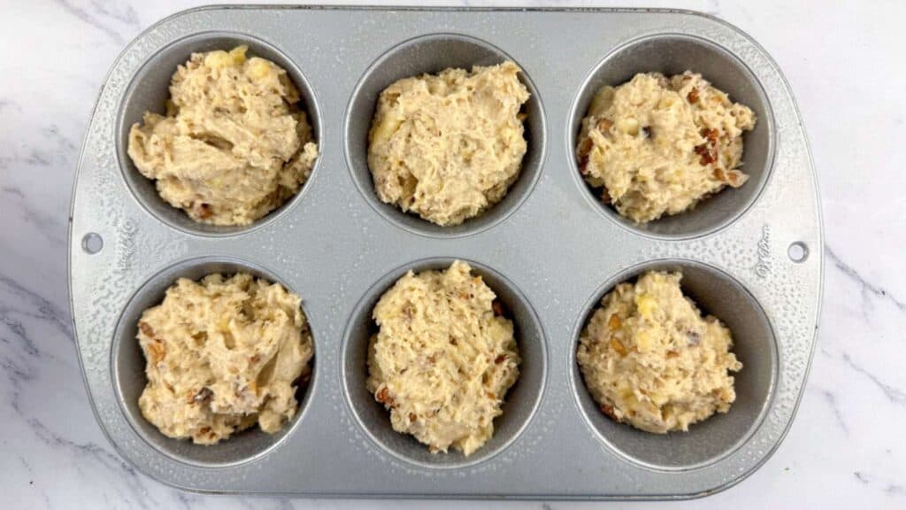 Divide the batter evenly among the prepared muffin cups,